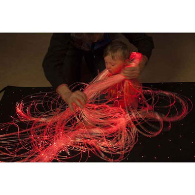 UFOL kid wrapped in fiber optic harness